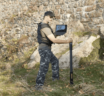 A man in a field making use of the OKM Fusion Professional Plus metal detector and groundscanner